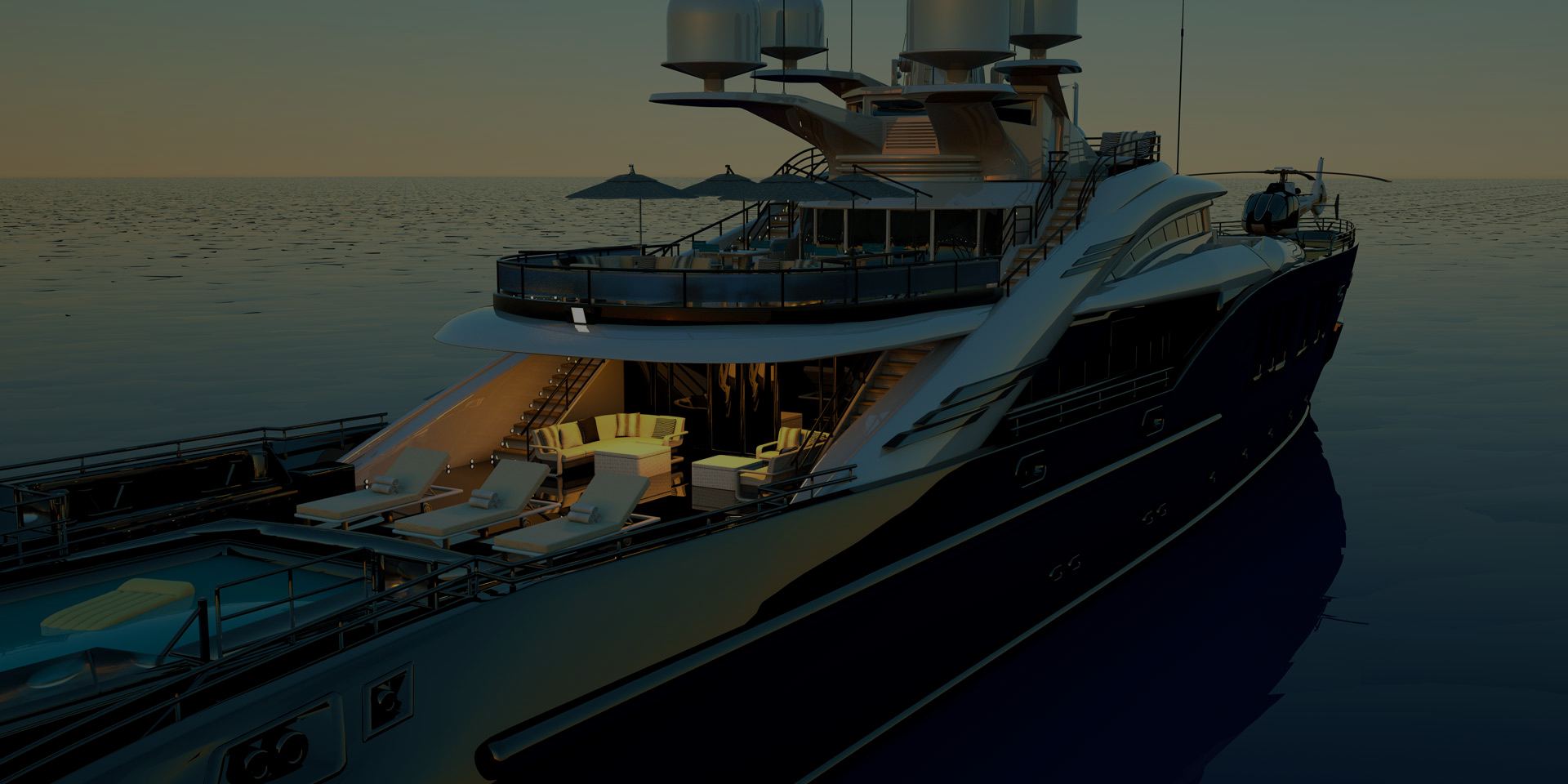 A superyacht at anchor in calm water at dusk